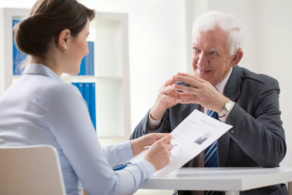 Un entretien d'embauche entre une recruteuse et un candidat senior, illustrant les opportunités offertes par le plan Activa à Bruxelles pour favoriser le retour à l’emploi.